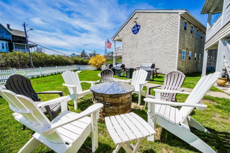 Photo of white chairs by fire pit